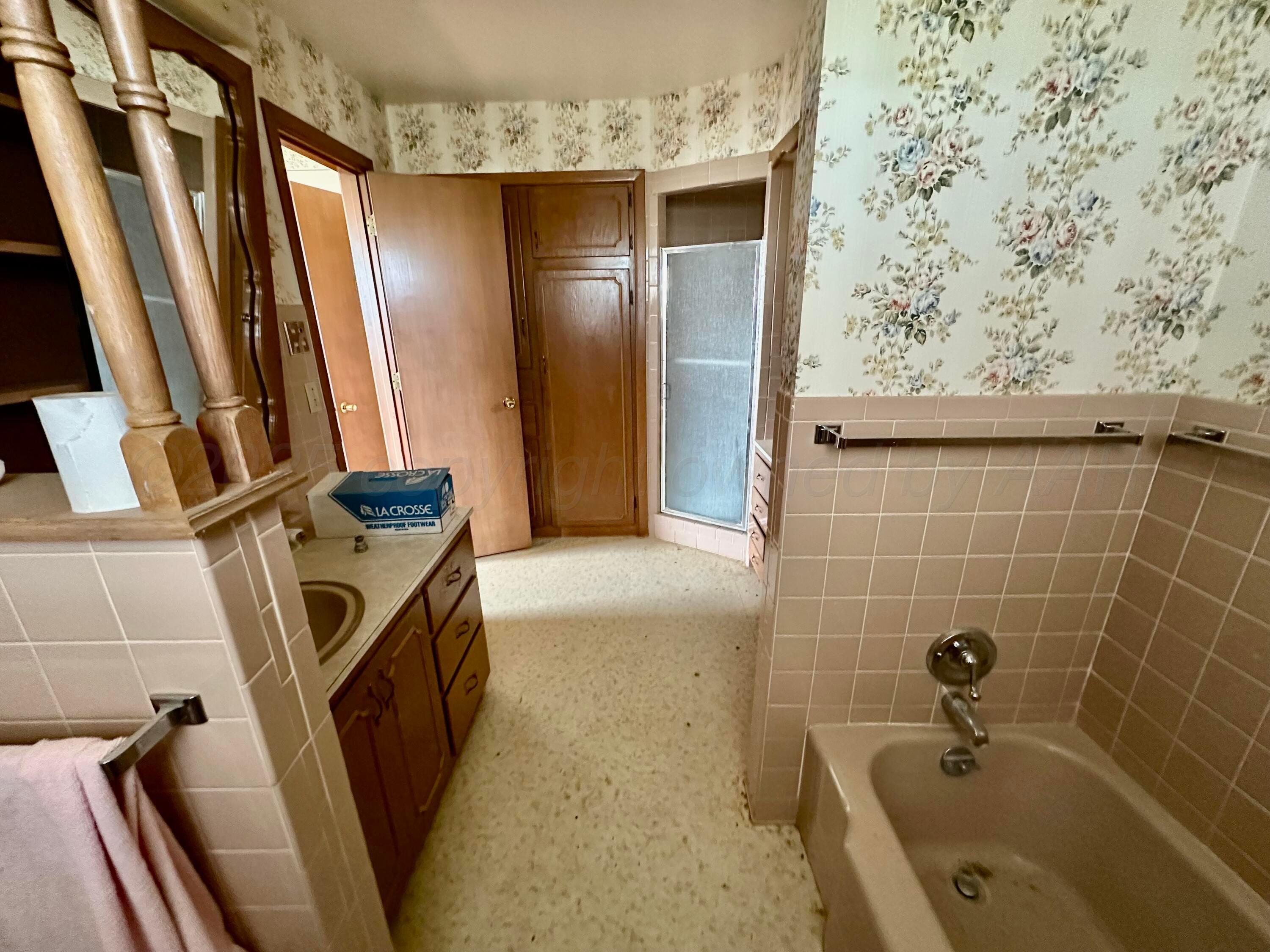 6675 Highway 86 Tulia, TX 79088 - Photo 66 of 68 a bathroom with a sink a tub and shower