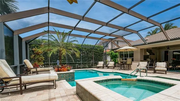 a swimming pool with outdoor seating