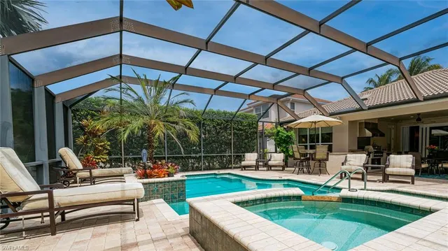 a swimming pool with outdoor seating