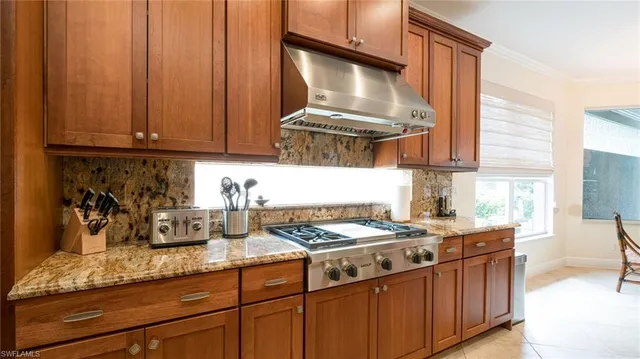 a kitchen with stainless steel appliances granite countertop a sink stove and cabinets