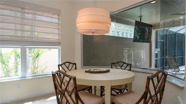 a view of a dining room with furniture and window