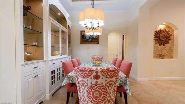 a view of a dining room with furniture and chandelier