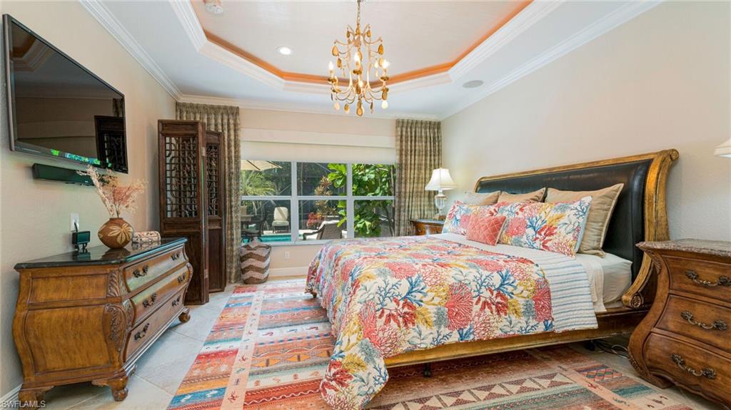 7667 Martino Circle Naples, FL 34112 - Photo 17 of 41 a bedroom with double bed and a flat tv screen