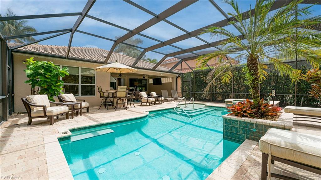 7667 Martino Circle Naples, FL 34112 - Photo 2 of 41 a view of a backyard with sitting area