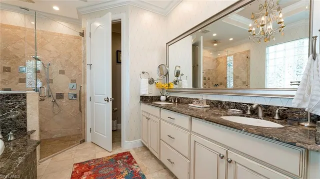 a bathroom with a double vanity sink mirror and shower