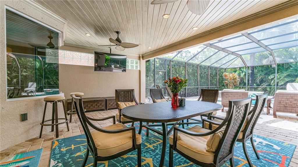 7667 Martino Circle Naples, FL 34112 - Photo 27 of 41 a view of an outdoor dining space with furniture and garden view