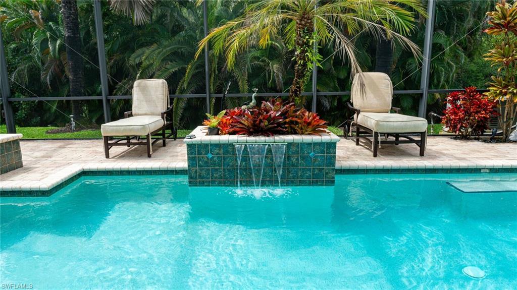 7667 Martino Circle Naples, FL 34112 - Photo 29 of 41 a garden view with a seating space