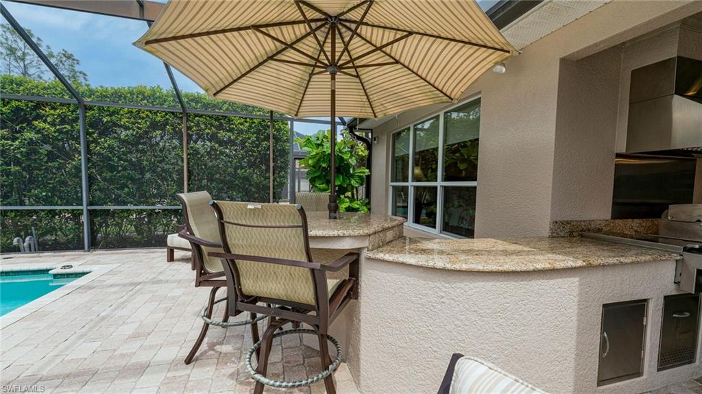 7667 Martino Circle Naples, FL 34112 - Photo 33 of 41 a table and chairs in patio