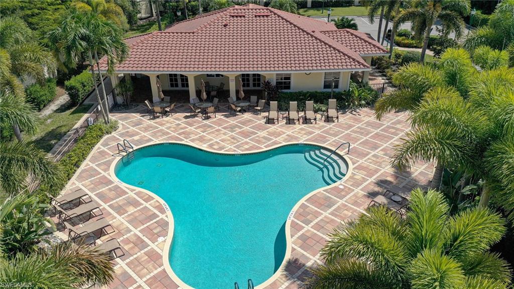7667 Martino Circle Naples, FL 34112 - Photo 38 of 41 a view of a house with pool and chairs