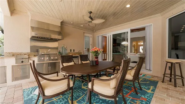 a dining room with furniture a rug and wooden floor