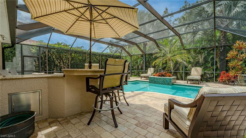 7667 Martino Circle Naples, FL 34112 - Photo 5 of 41 a view of a backyard with sitting area