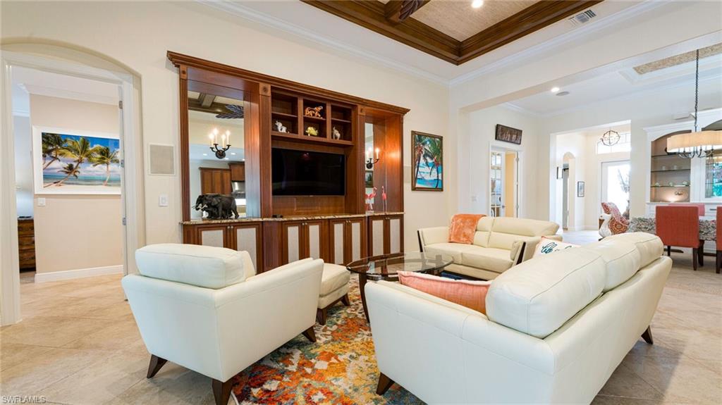 7667 Martino Circle Naples, FL 34112 - Photo 8 of 41 a living room with furniture and a potted plant