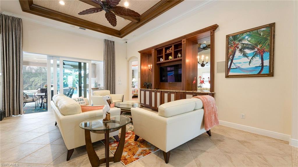 7667 Martino Circle Naples, FL 34112 - Photo 9 of 41 a living room with furniture and a large window