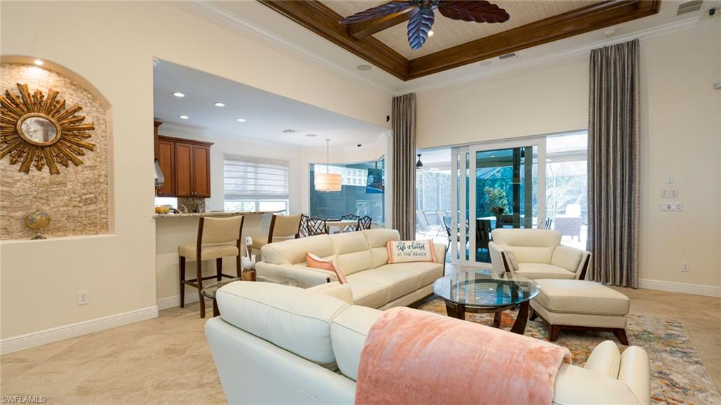 7667 Martino Circle Naples, FL 34112 - Photo 10 of 41 a living room with furniture and a large window