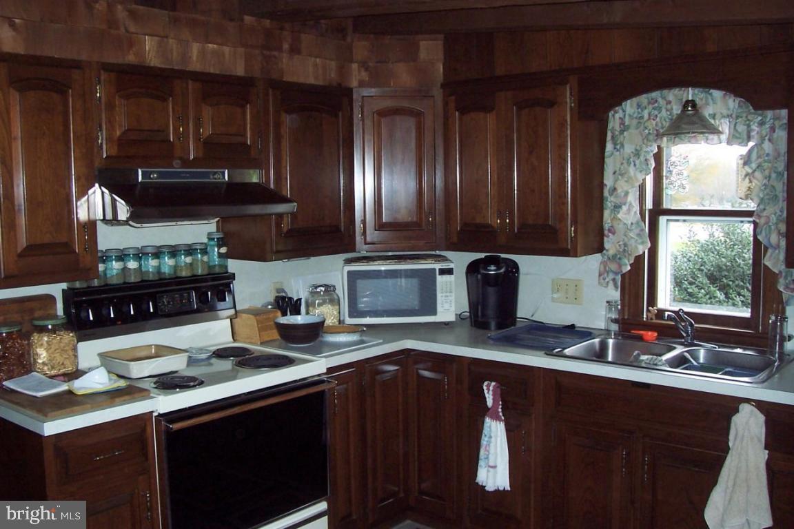 172 Oak Bottom Road Quarryville, PA 17566 - Photo 6 of 17 a kitchen with stainless steel appliances granite countertop a sink stove and cabinets