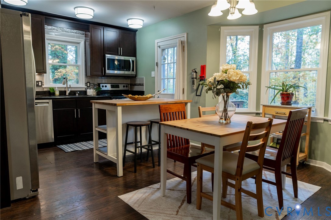 8603 Boones Bluff Mews, Unit MEWS Chesterfield, VA 23832 - Photo 11 of 46 a kitchen with a dining table and chairs