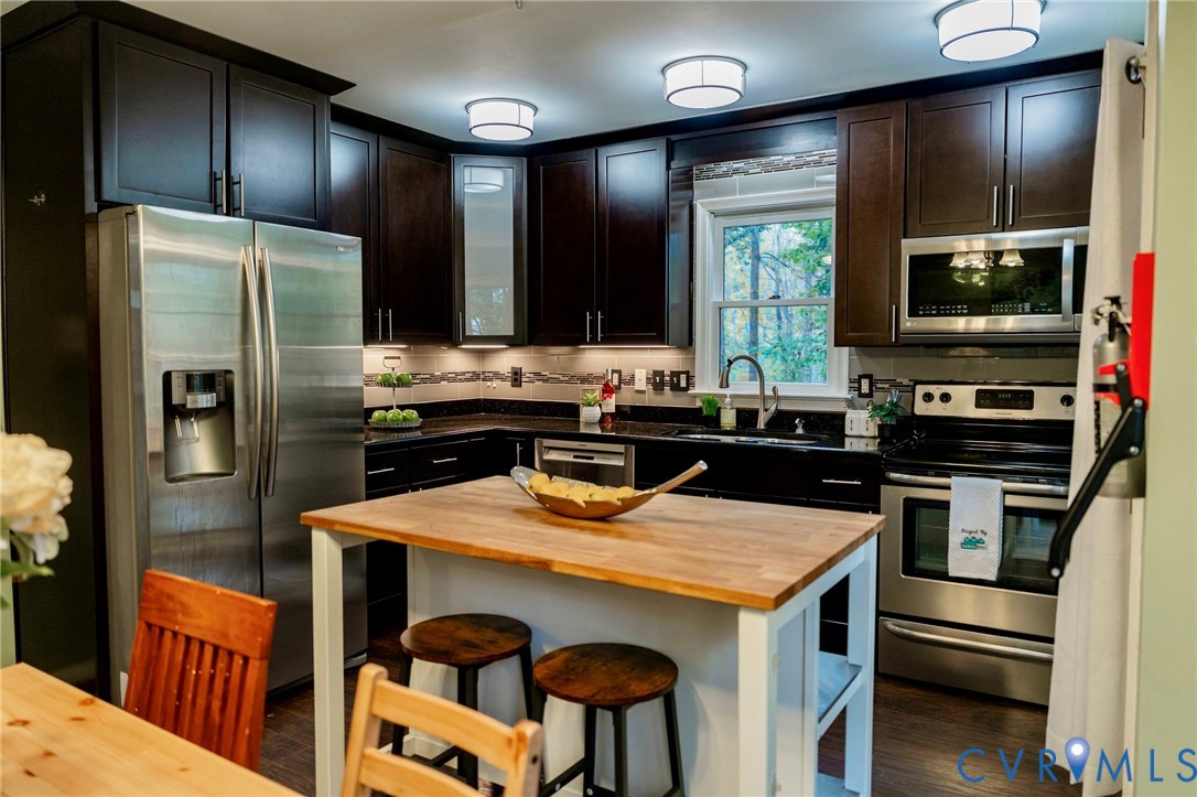 8603 Boones Bluff Mews, Unit MEWS Chesterfield, VA 23832 - Photo 12 of 46 a kitchen with stainless steel appliances a sink and a refrigerator