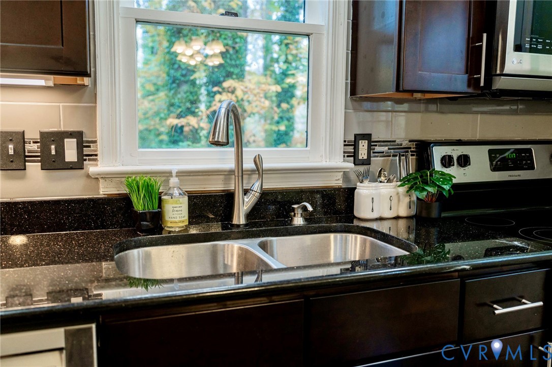 8603 Boones Bluff Mews, Unit MEWS Chesterfield, VA 23832 - Photo 15 of 46 a kitchen with a sink a counter space and cabinets
