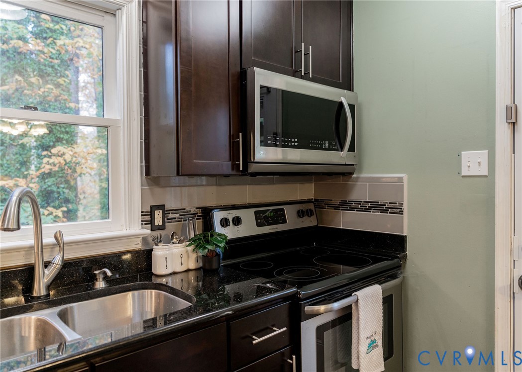 8603 Boones Bluff Mews, Unit MEWS Chesterfield, VA 23832 - Photo 16 of 46 a kitchen with a sink stove and microwave