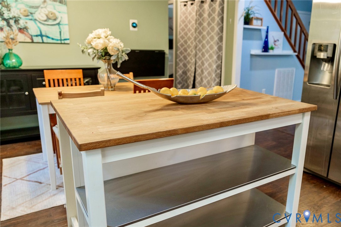 8603 Boones Bluff Mews, Unit MEWS Chesterfield, VA 23832 - Photo 18 of 46 a room with a table and a fireplace