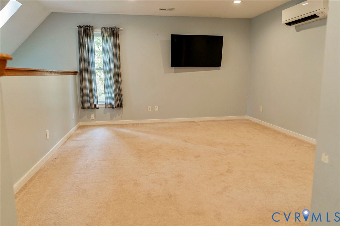 8603 Boones Bluff Mews, Unit MEWS Chesterfield, VA 23832 - Photo 28 of 46 a view of an empty room with wooden floor and a flat screen tv