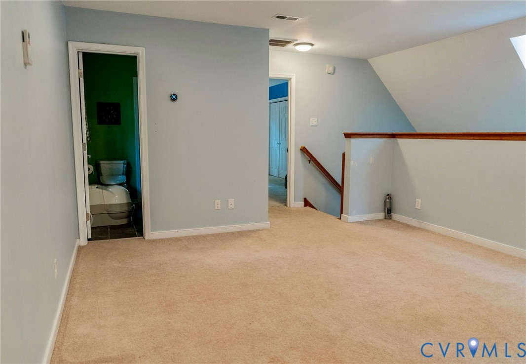 8603 Boones Bluff Mews, Unit MEWS Chesterfield, VA 23832 - Photo 40 of 46 a view of an empty room with wooden floor and stairs