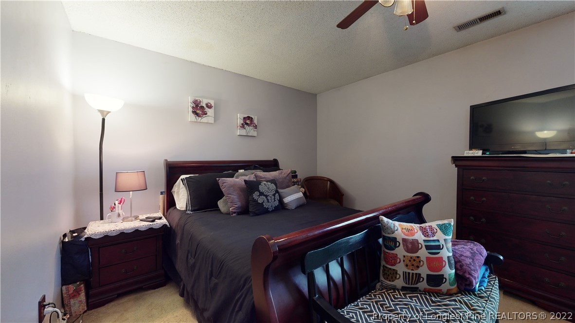 4604 Pine Trace Drive Raleigh, NC 27613 - Photo 14 of 30 a bed room with a bed window and a flat screen tv