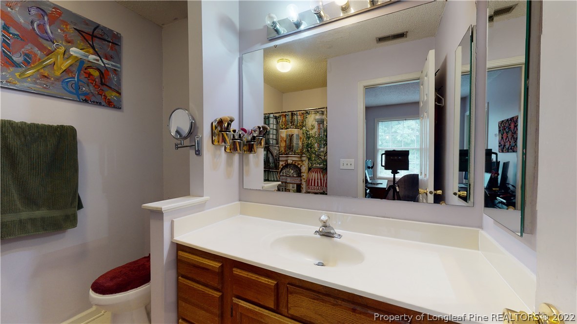 4604 Pine Trace Drive Raleigh, NC 27613 - Photo 16 of 30 a bathroom with a sink and a mirror