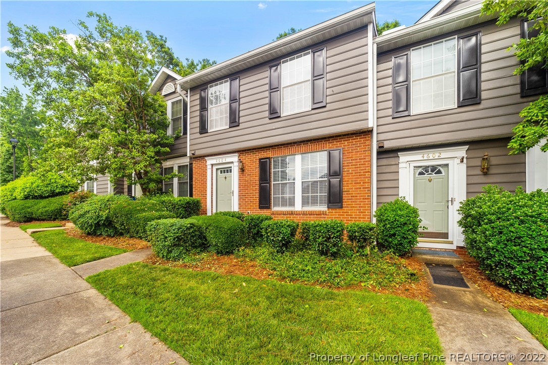 4604 Pine Trace Drive Raleigh, NC 27613 - Photo 29 of 30 a view of a house with brick walls plants and large windows