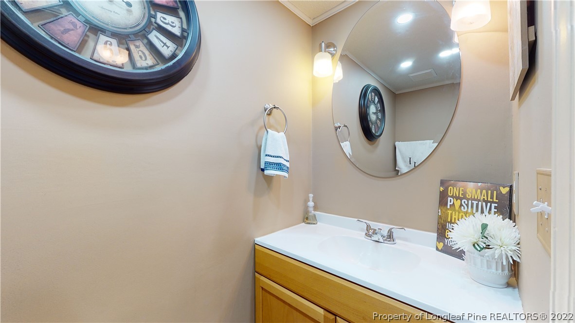 4604 Pine Trace Drive Raleigh, NC 27613 - Photo 8 of 30 a bathroom with a sink and a mirror