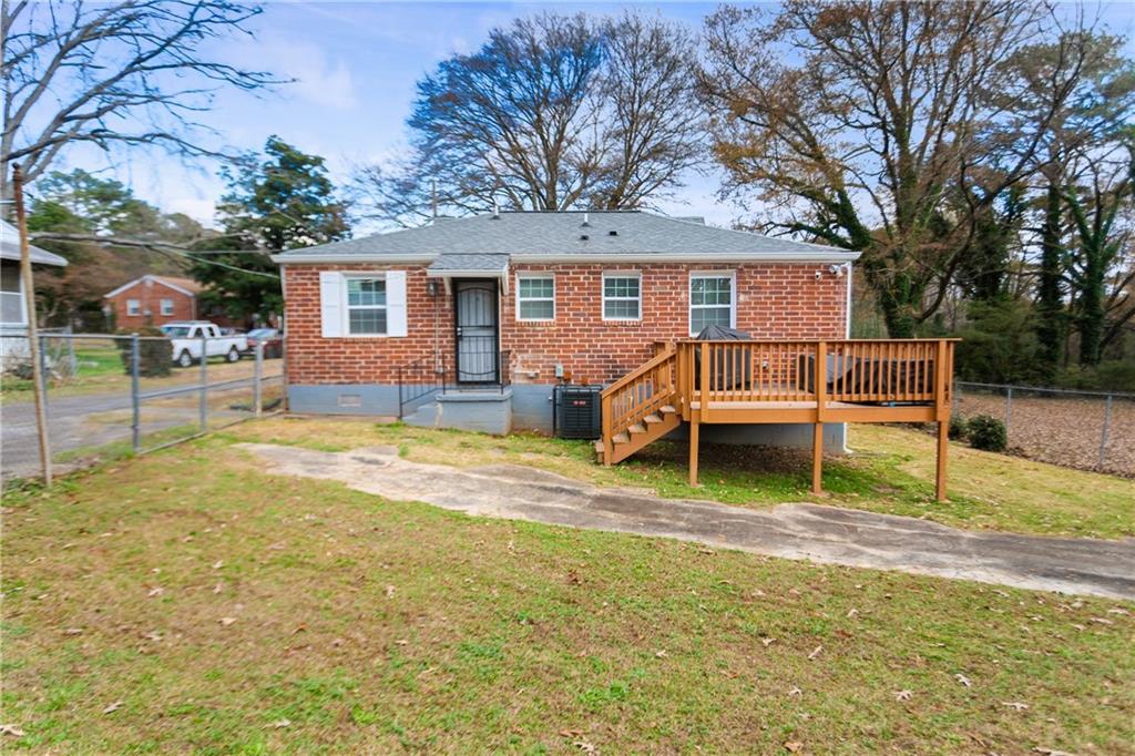 142 Hutton Place Northwest Atlanta, GA 30318 - Photo 2 of 14 a view of a house with a yard