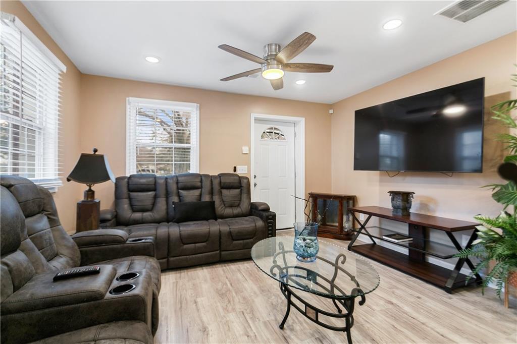 142 Hutton Place Northwest Atlanta, GA 30318 - Photo 3 of 14 a living room with furniture and a flat screen tv