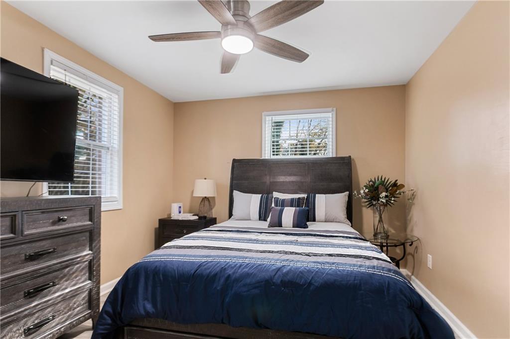 142 Hutton Place Northwest Atlanta, GA 30318 - Photo 5 of 14 a bedroom with a bed and a flat screen tv