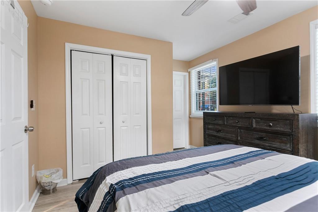 142 Hutton Place Northwest Atlanta, GA 30318 - Photo 6 of 14 a bedroom with a bed and a flat screen tv