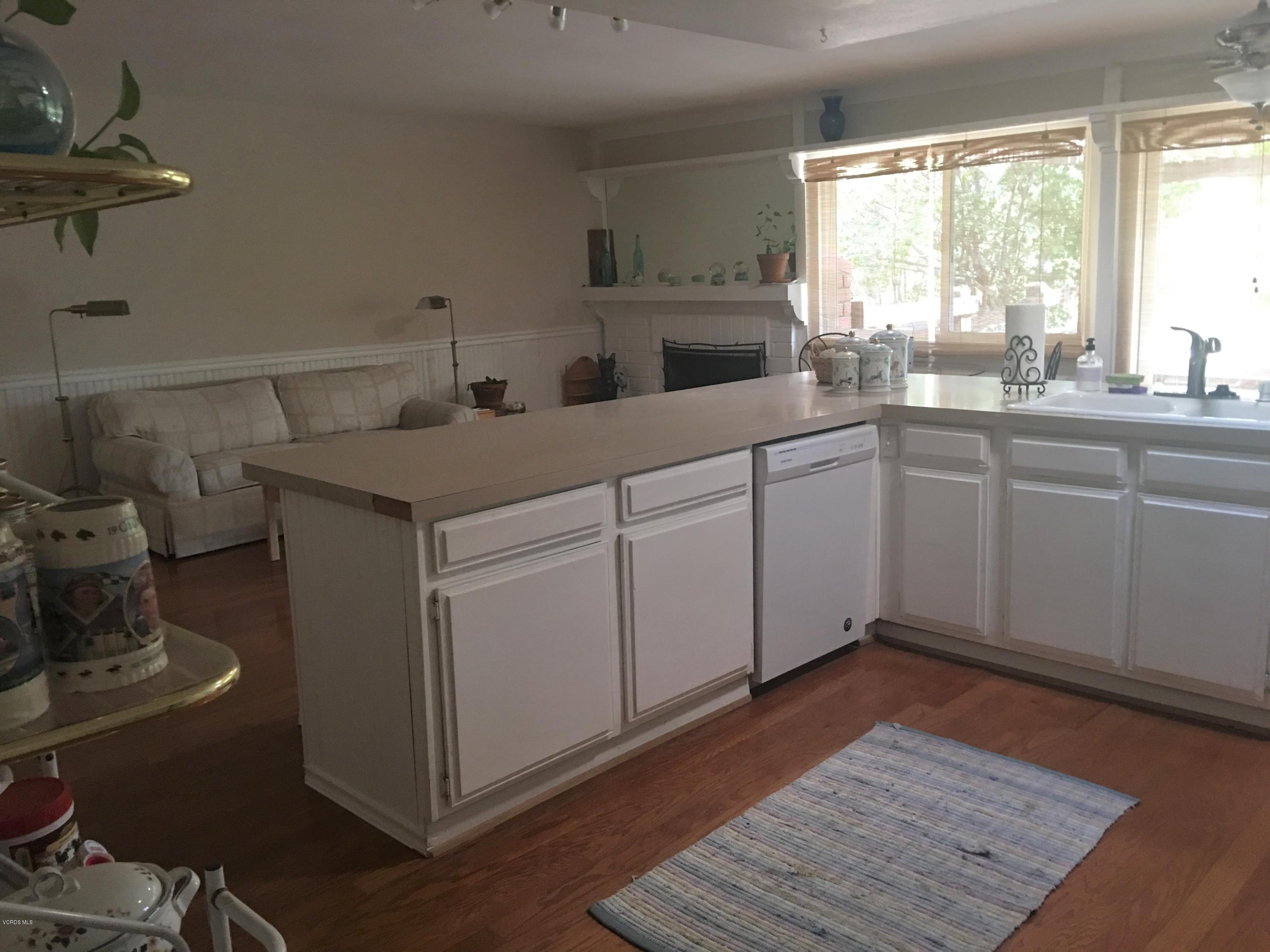 718 Tranquil Lane Simi Valley, CA 93065 - Photo 16 of 68 a kitchen with sink cabinets and wooden floor