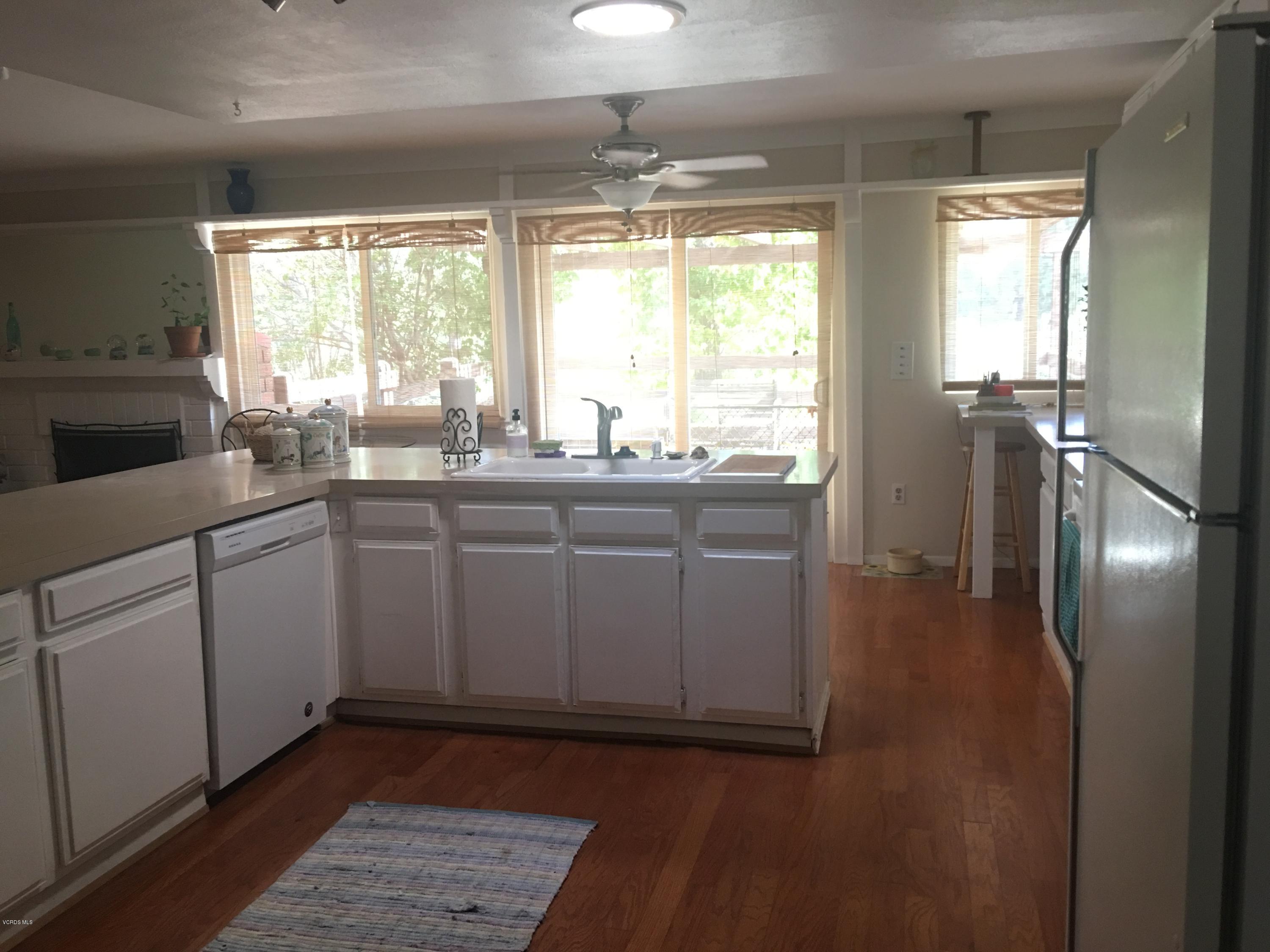 718 Tranquil Lane Simi Valley, CA 93065 - Photo 17 of 68 a kitchen with a sink window and cabinets