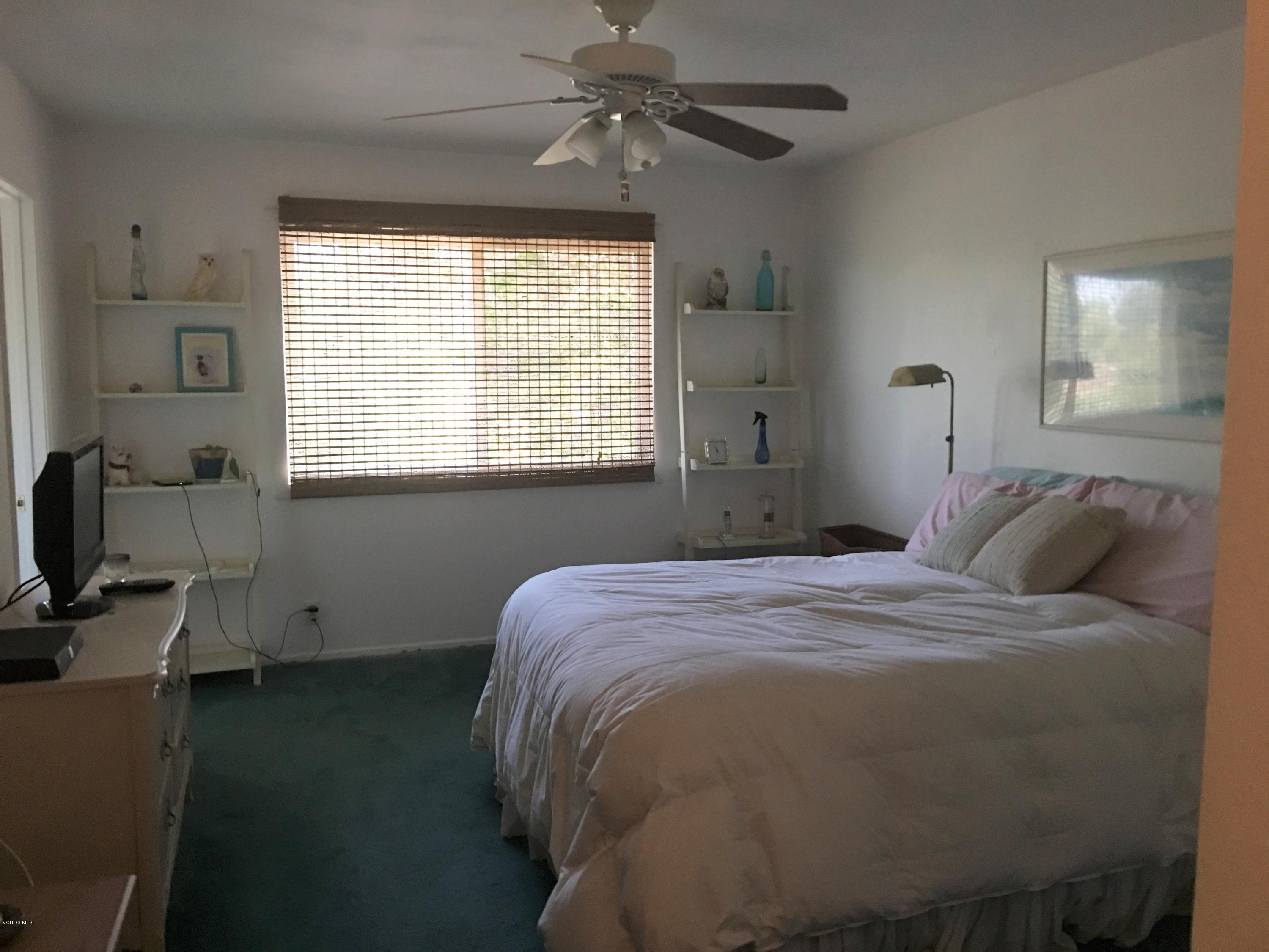718 Tranquil Lane Simi Valley, CA 93065 - Photo 21 of 68 a bedroom with a bed and a chandelier