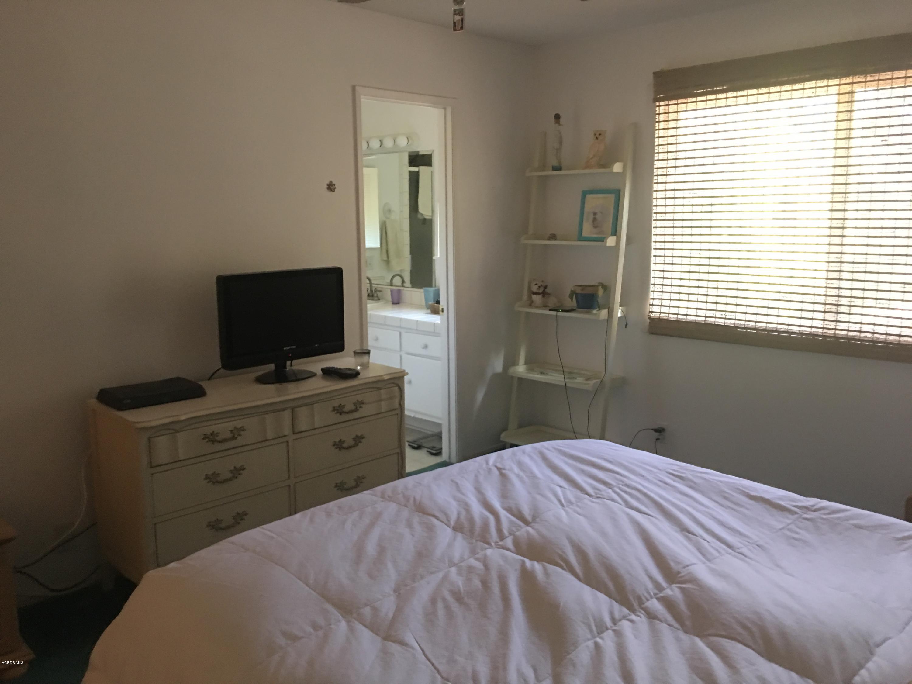 718 Tranquil Lane Simi Valley, CA 93065 - Photo 22 of 68 a bedroom with a bed and a flat screen tv