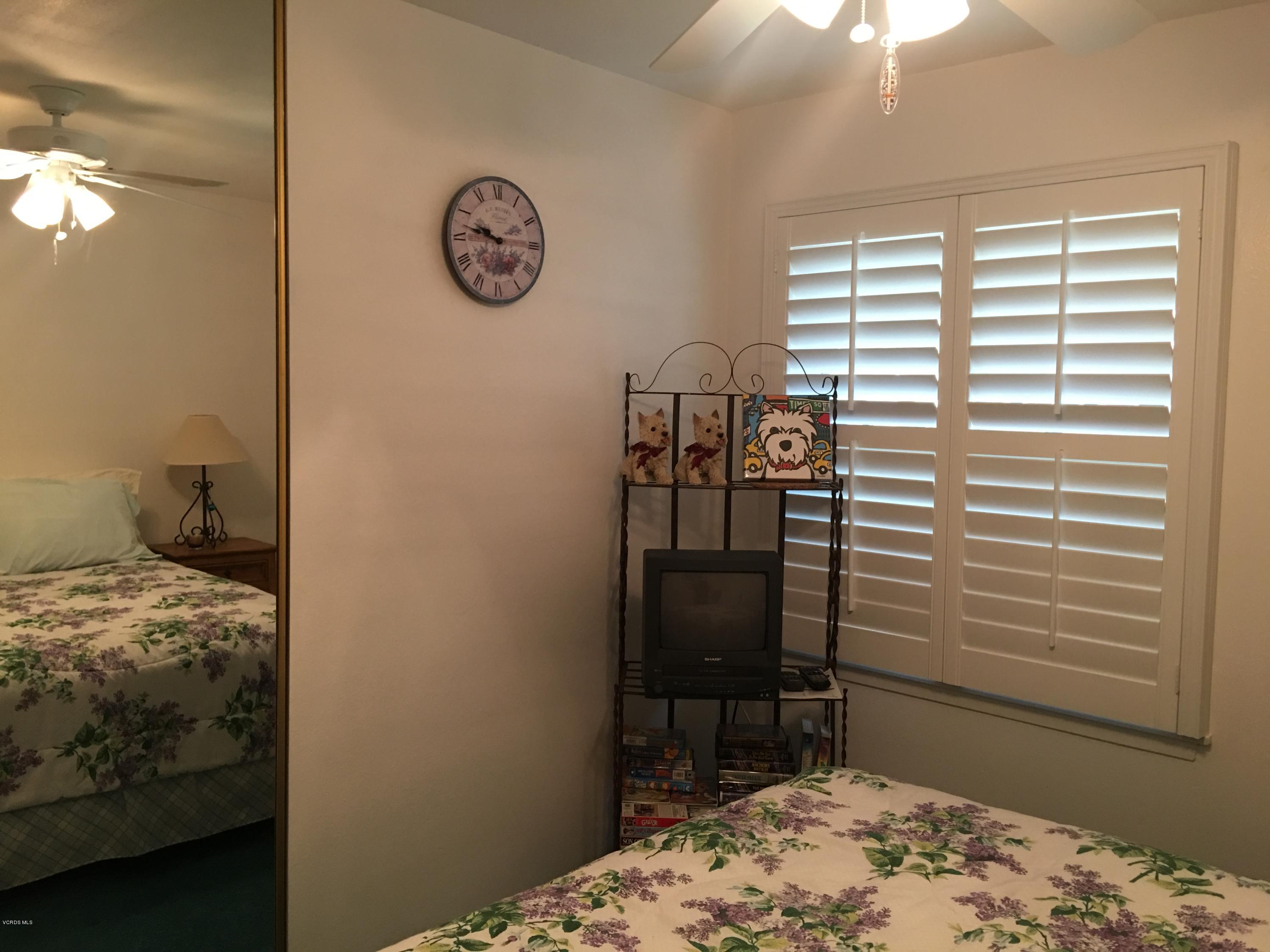 718 Tranquil Lane Simi Valley, CA 93065 - Photo 34 of 68 a bedroom with a bed and a chair