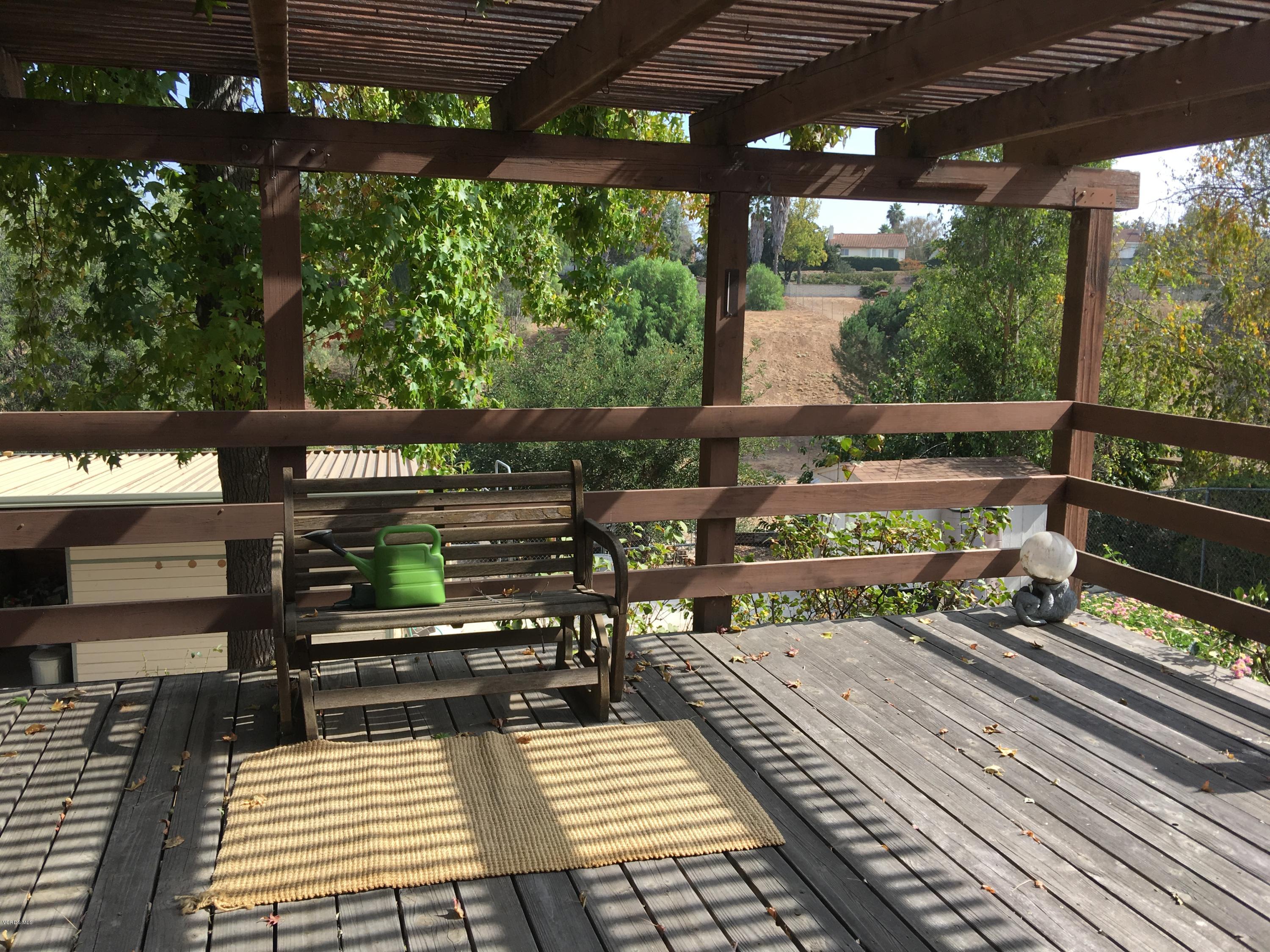 718 Tranquil Lane Simi Valley, CA 93065 - Photo 42 of 68 a view of a wooden deck with a bench