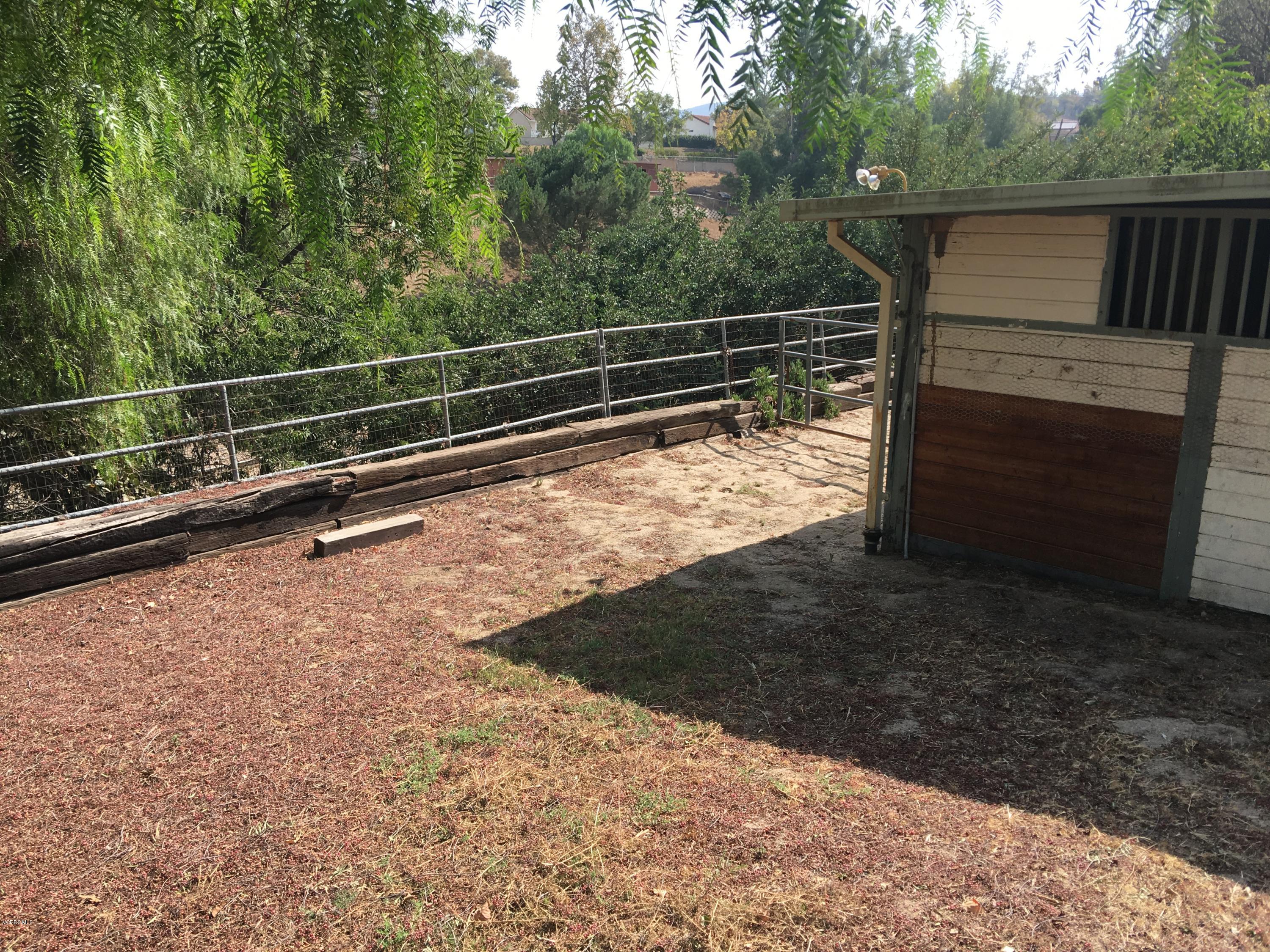718 Tranquil Lane Simi Valley, CA 93065 - Photo 58 of 68 a view of a forest with a bench