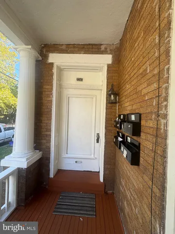 a view of a closet area with wooden floor