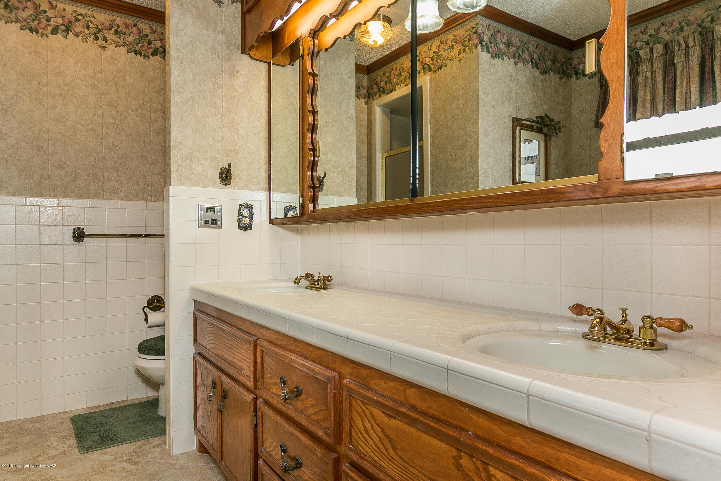 8117 Santa Fe Trail Amarillo, TX 79110 - Photo 15 of 27 a bathroom with a sink and a mirror