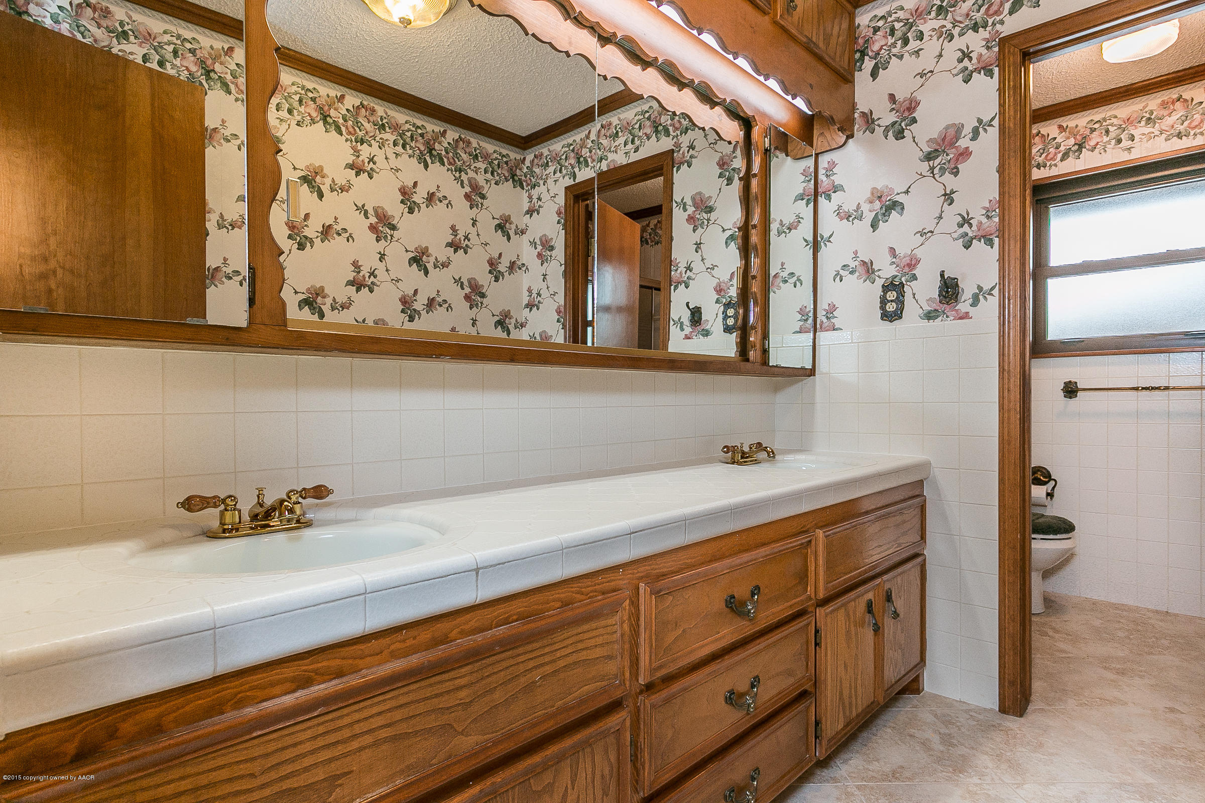 8117 Santa Fe Trail Amarillo, TX 79110 - Photo 19 of 27 a bathroom with a sink and a mirror