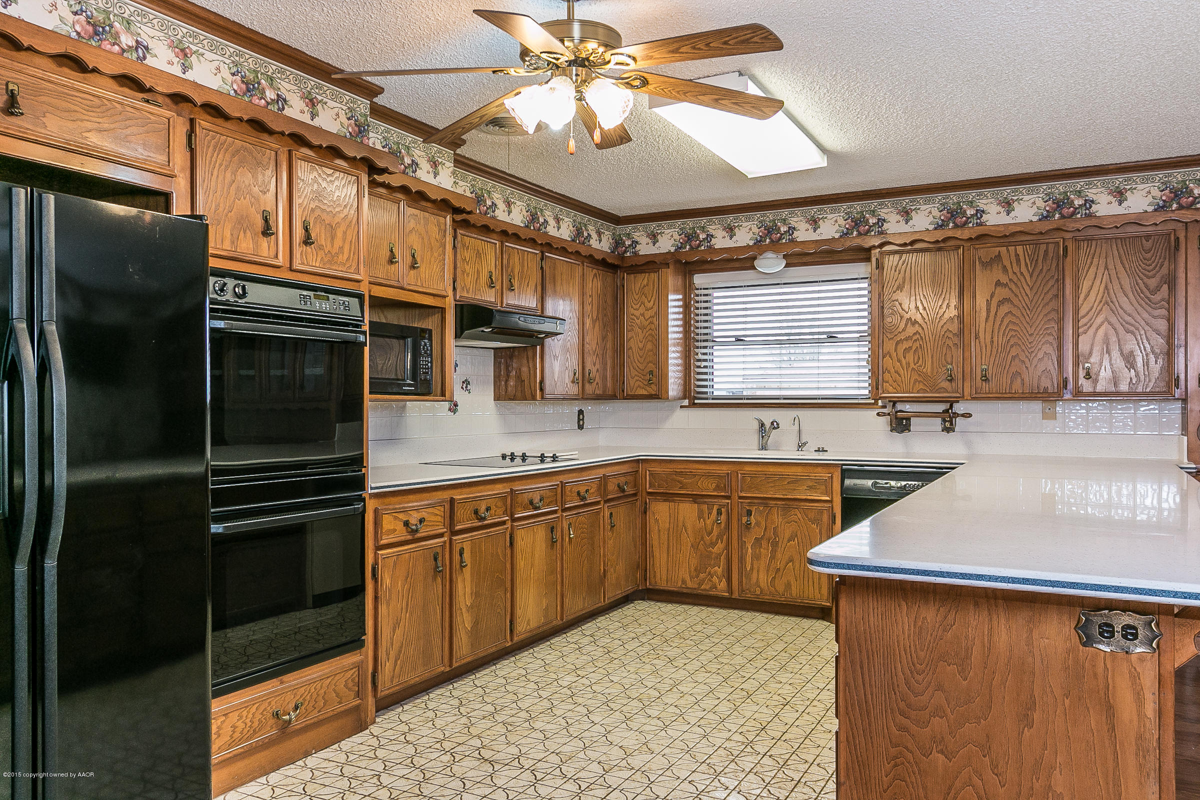 8117 Santa Fe Trail Amarillo, TX 79110 - Photo 9 of 27 a kitchen with stainless steel appliances granite countertop a sink stove and refrigerator