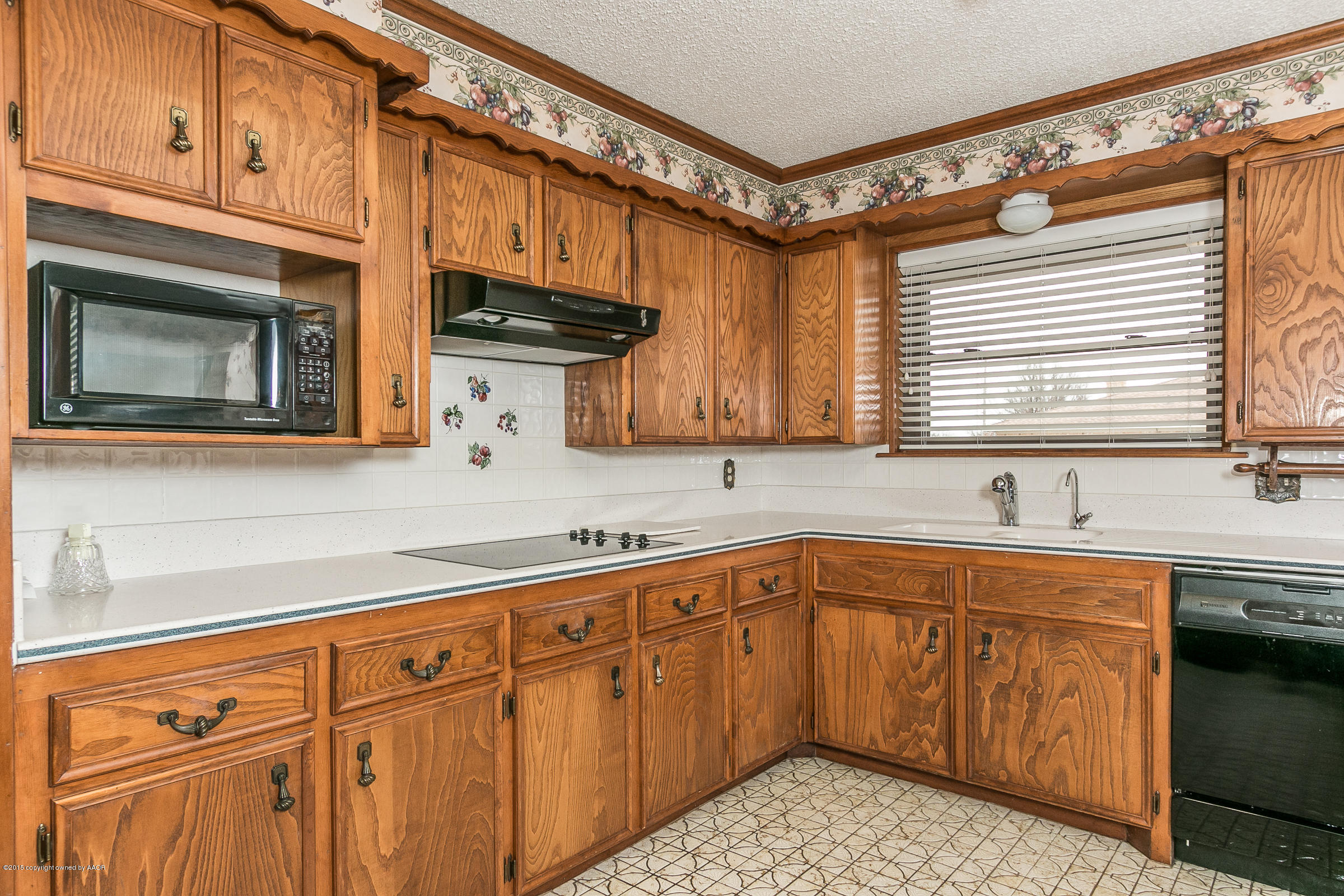 8117 Santa Fe Trail Amarillo, TX 79110 - Photo 10 of 27 a kitchen with stainless steel appliances granite countertop a sink a stove and cabinets