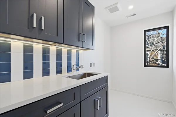 a kitchen with a sink and cabinets