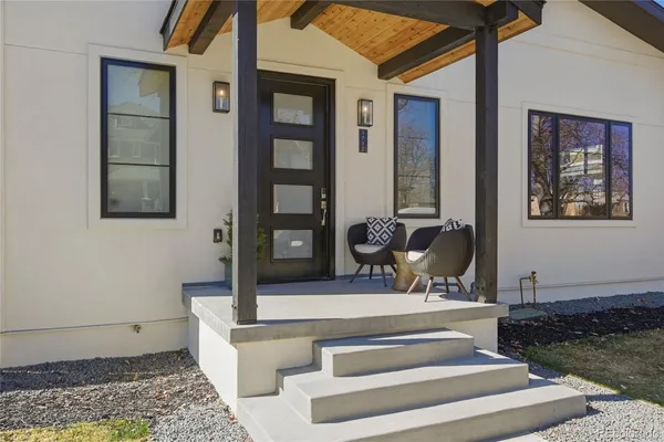 a view of staircase with white walls and glass windows