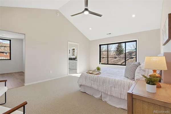 a bedroom with a large bed and a window