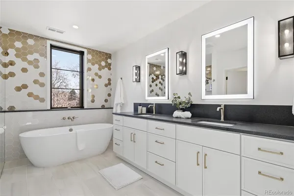 a bathroom with sink bathtub and window